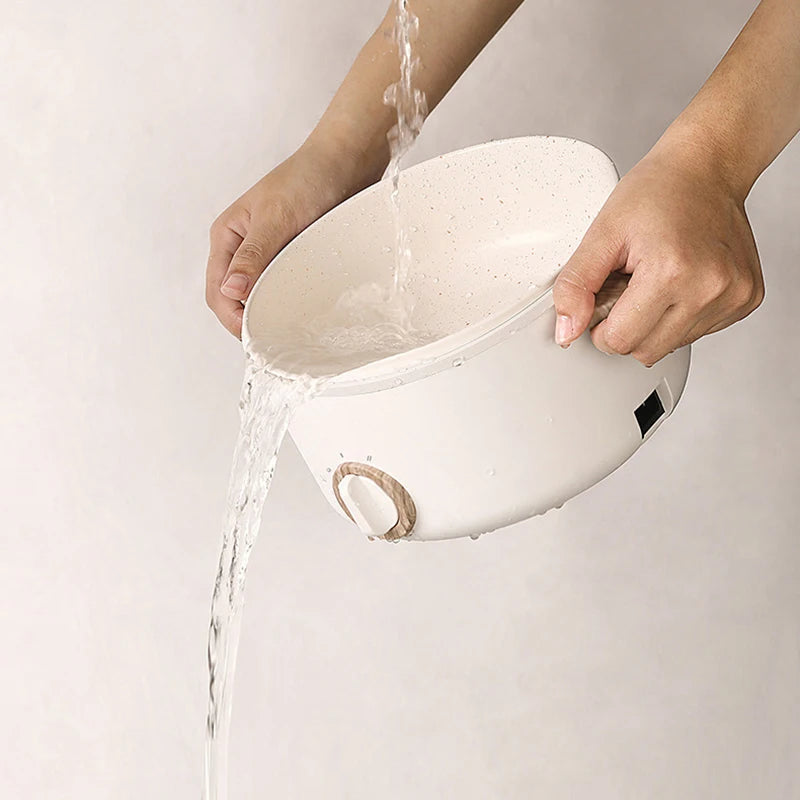 Hands rinsing Multi-function Mini Cooker under water, showcasing easy cleaning with non-stick coating and detachable wire.