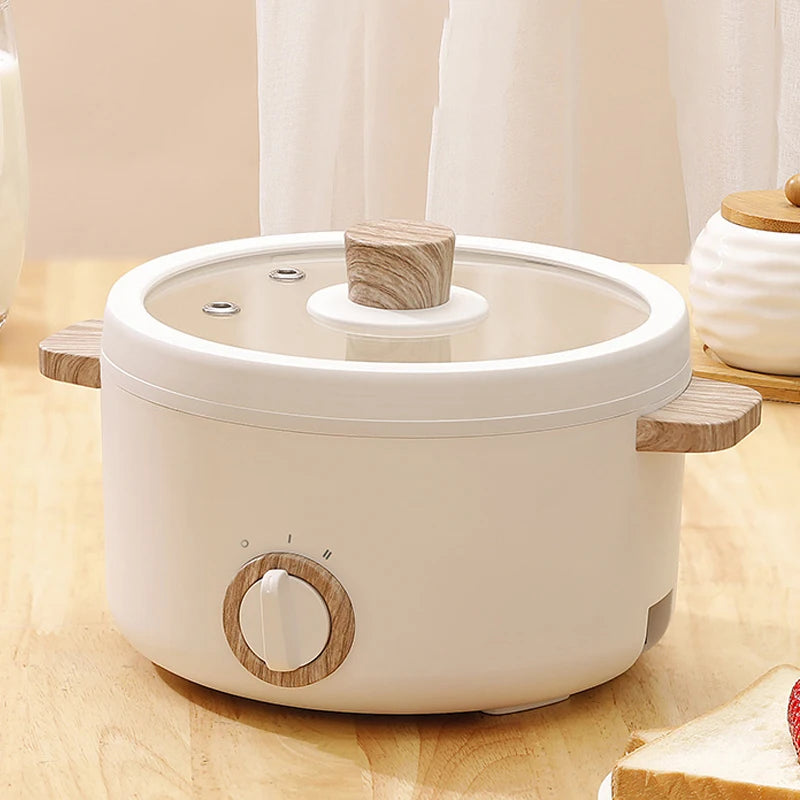 Multi-function Mini Cooker on a kitchen counter with bread, strawberries, milk, and a bowl, ideal for small kitchen spaces.