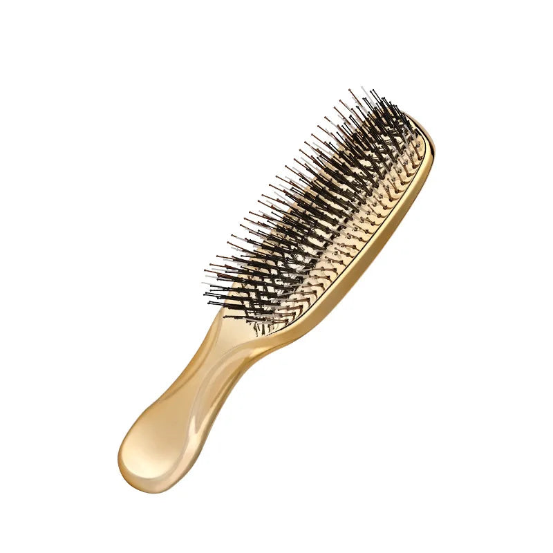 Close-up of golden hair massage comb – luxury styling tool for healthy, tangle-free hair