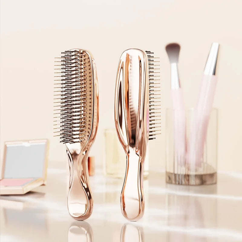 Two rose gold massage combs on vanity – perfect for styling, detangling, and scalp cleansing