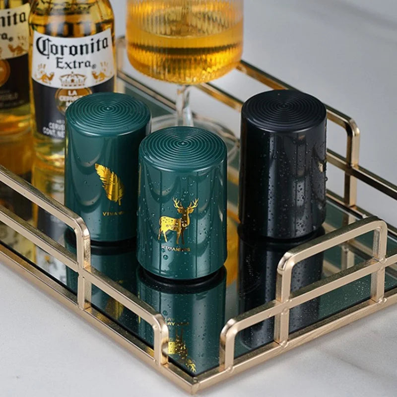 Elegant beer openers displayed on golden tray with bottles and glasses