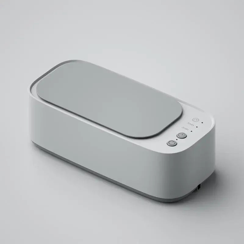 Compact white ultrasonic cleaner with closed lid on a minimalist background.