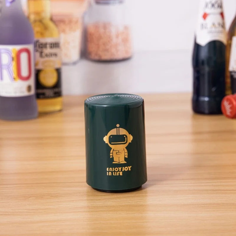 Magnetic beer bottle opener with cute robot print standing on wooden table