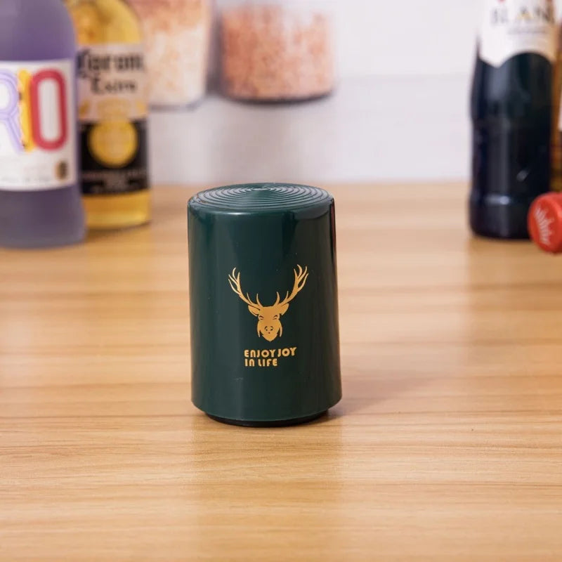 Green beer opener with deer logo and enjoy joy in life text on wood table