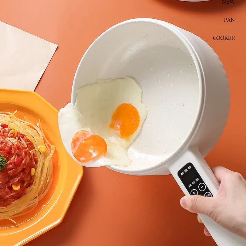 Non-stick electric cooker frying eggs with easy pour design