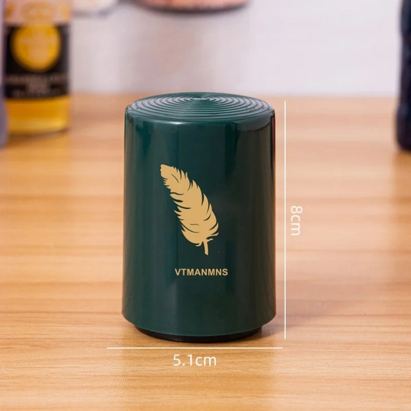 Dark green beer bottle opener with feather logo showing 8cm height and 5.1cm width