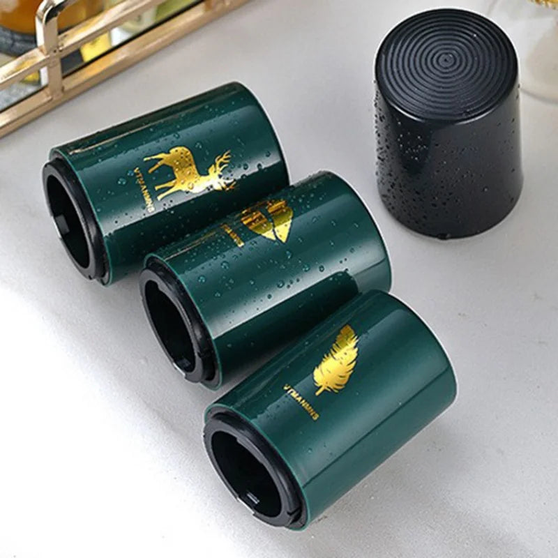 Close-up of beer openers with feather, lips, and deer designs on tabletop