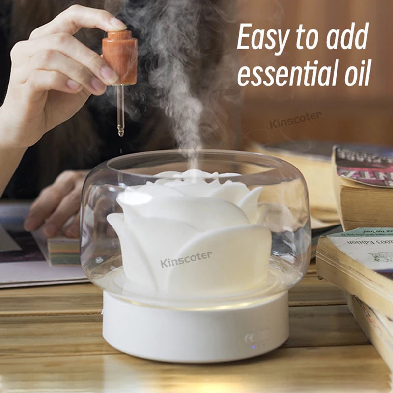 Hand adding essential oil to the KINSCOTER diffuser, showing simple refill design