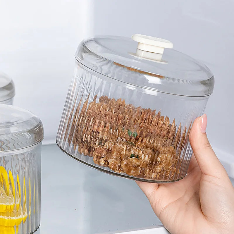 Hand holding a Meatball Maker container filled with meatball mixture, showcasing its transparent ribbed design.