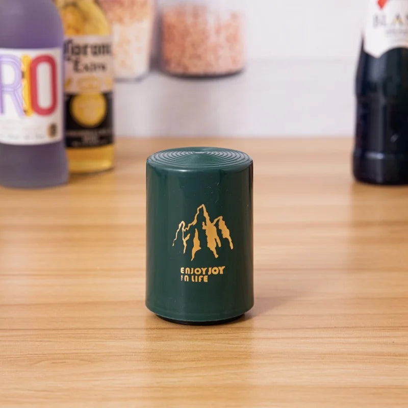 Green beer opener with golden mountain print and enjoy joy in life slogan