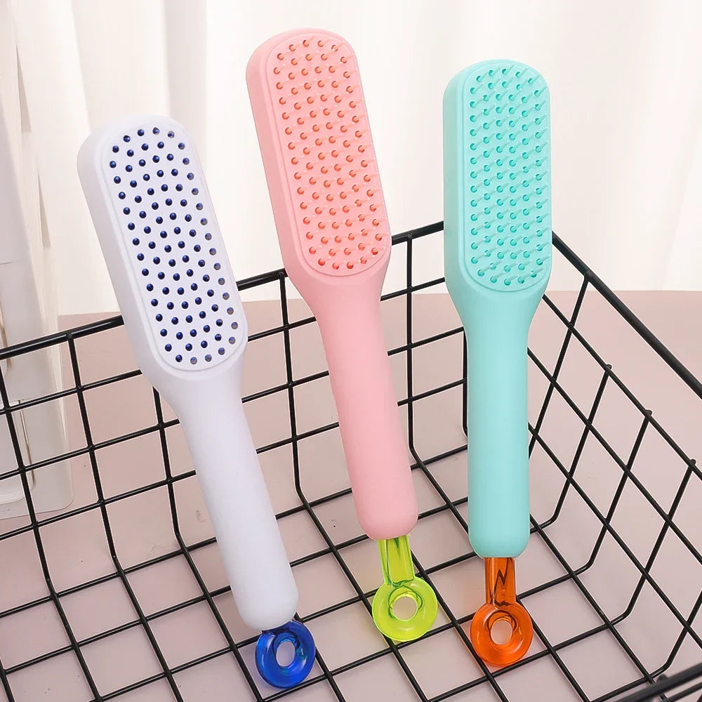 Three pastel telescopic hair combs in a basket – pink, mint, and white colors