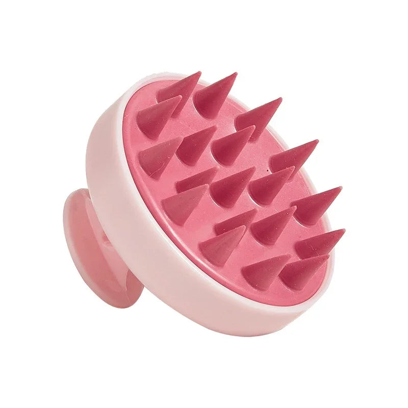 Pink grooming tool with spike-like projections on a white background