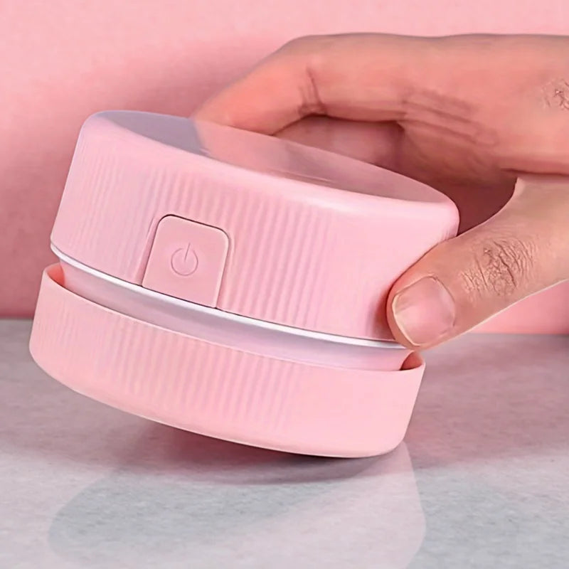 Pink container with a power button held by a hand on a light pink background