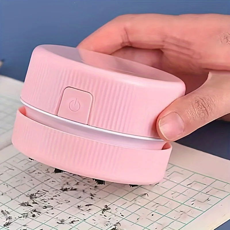 Pink handheld device with a power button on a grid surface