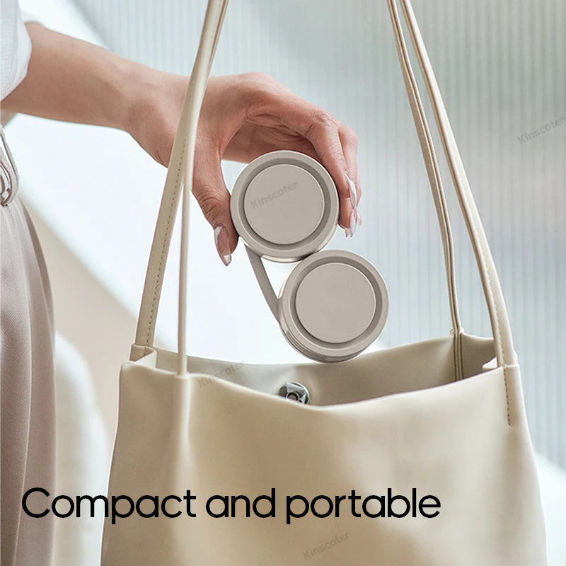Portable neck fan being placed in handbag – compact and travel-friendly design