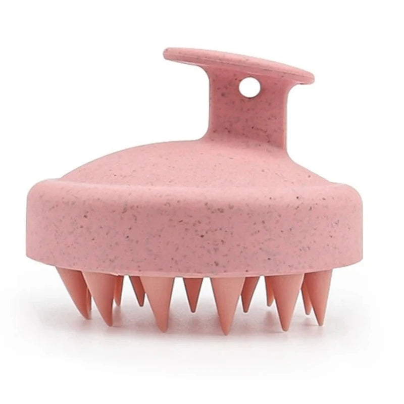 Pink Silicone Shampoo Brush with soft bristles, designed for scalp exfoliation and hair care, shown on a white background.