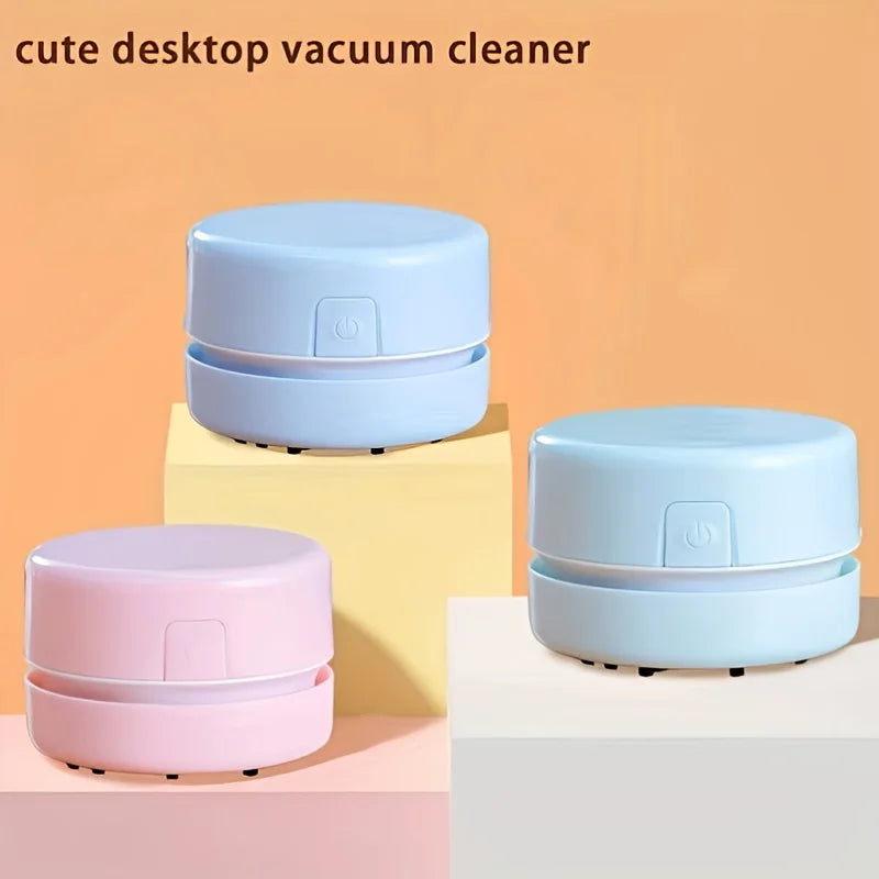 Three mini pastel vacuum cleaners on the desk.
