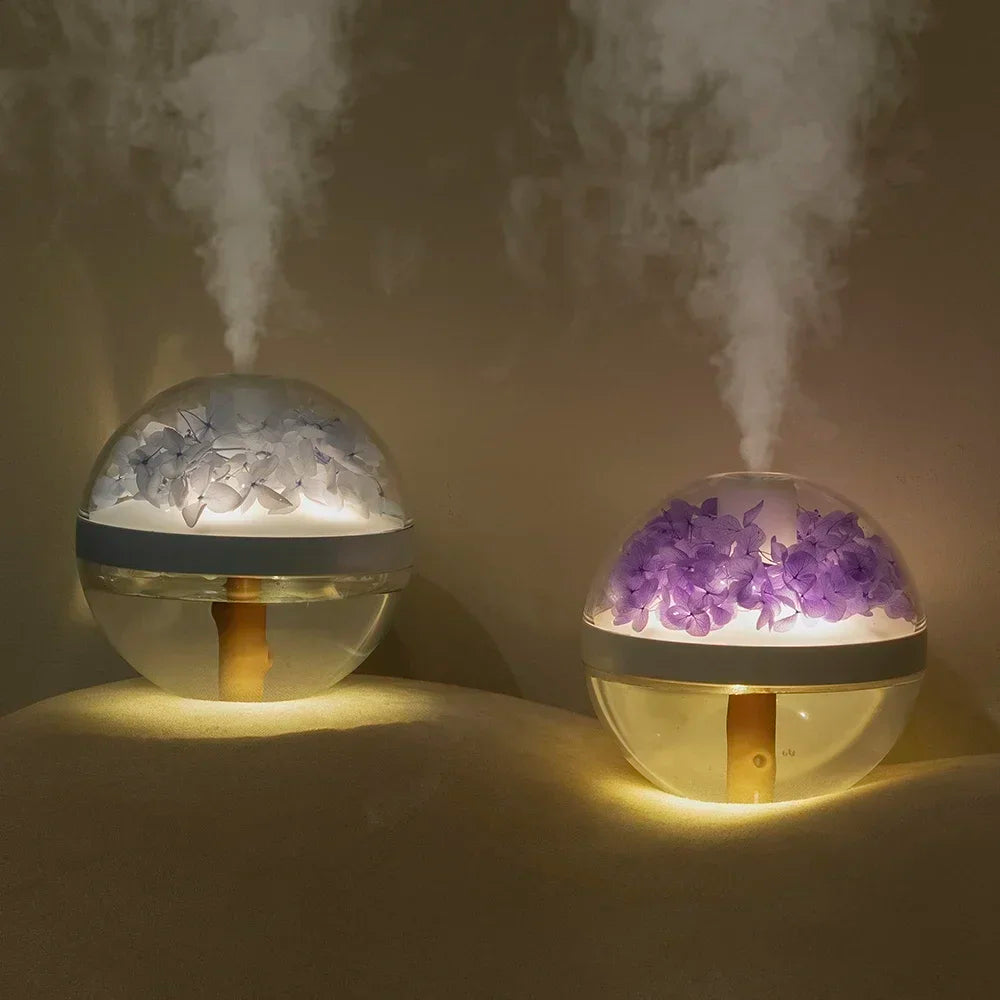 Two spherical humidifiers emitting mist with decorative elements inside on a dark background
