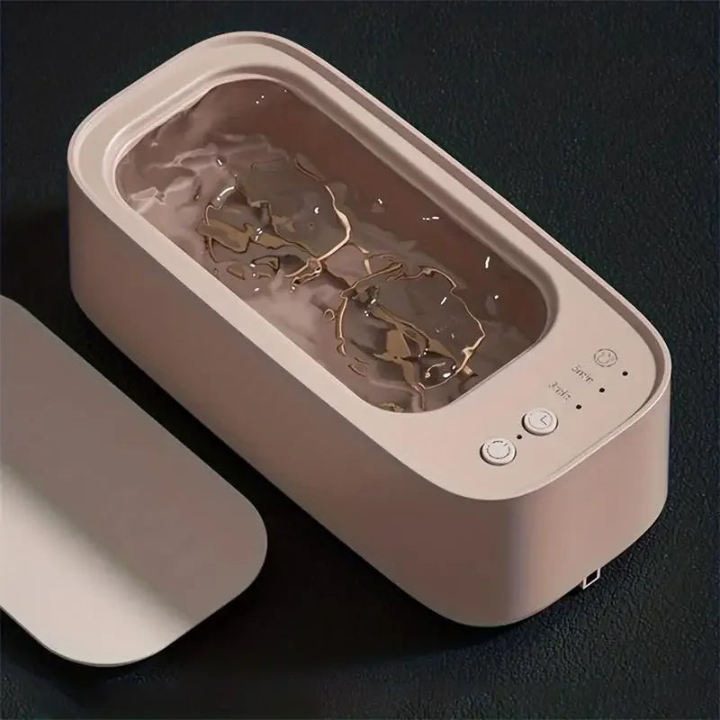 Ultrasonic cleaner in action, cleaning eyeglasses with visible water agitation.