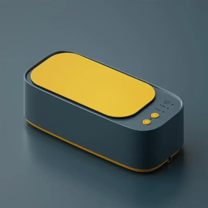 Modern dark blue ultrasonic cleaner with vibrant yellow lid, sleek design.