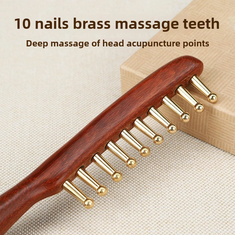 Wooden comb with gold massage teeth on a beige background