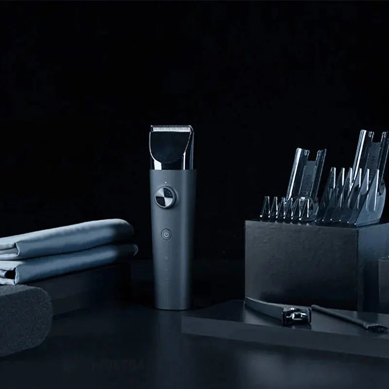 XIAOMI MIJIA Hair Trimmer Machine with multiple comb attachments, cleaning brush, and oil bottle on a dark surface for grooming.