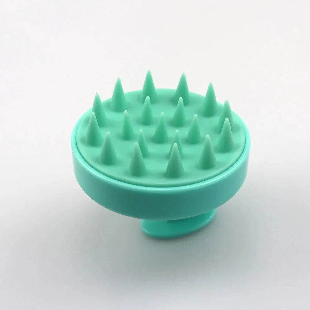 Turquoise silicone brush with spike-like bristles on a white background