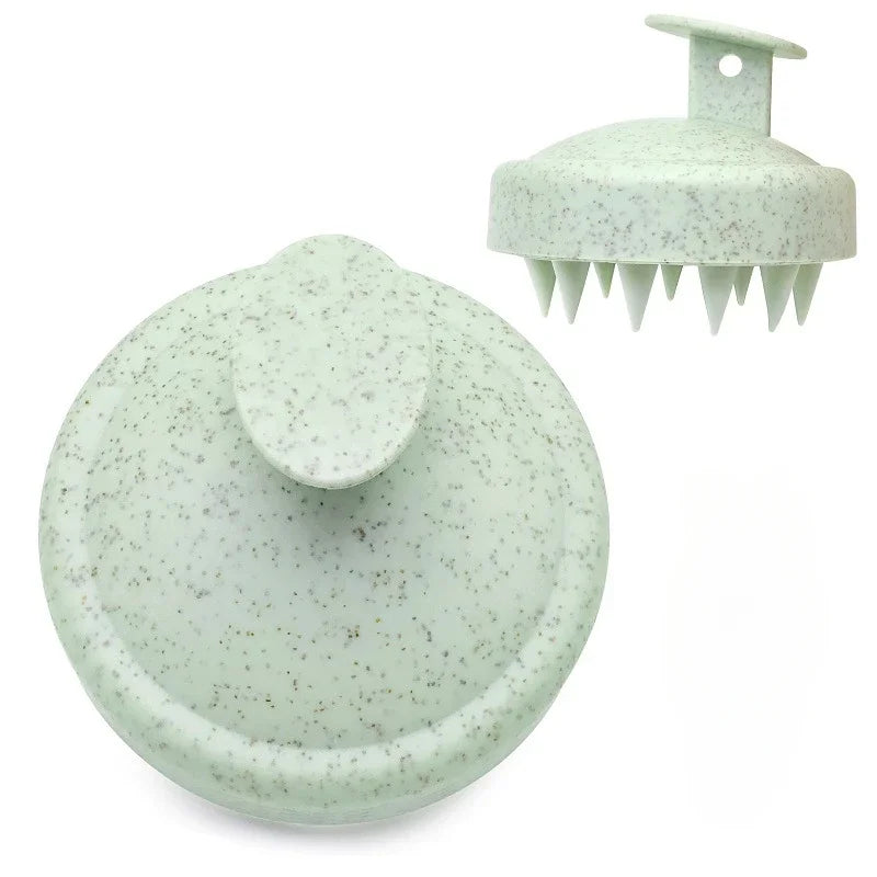 Two green speckled scalp massagers on a white background
