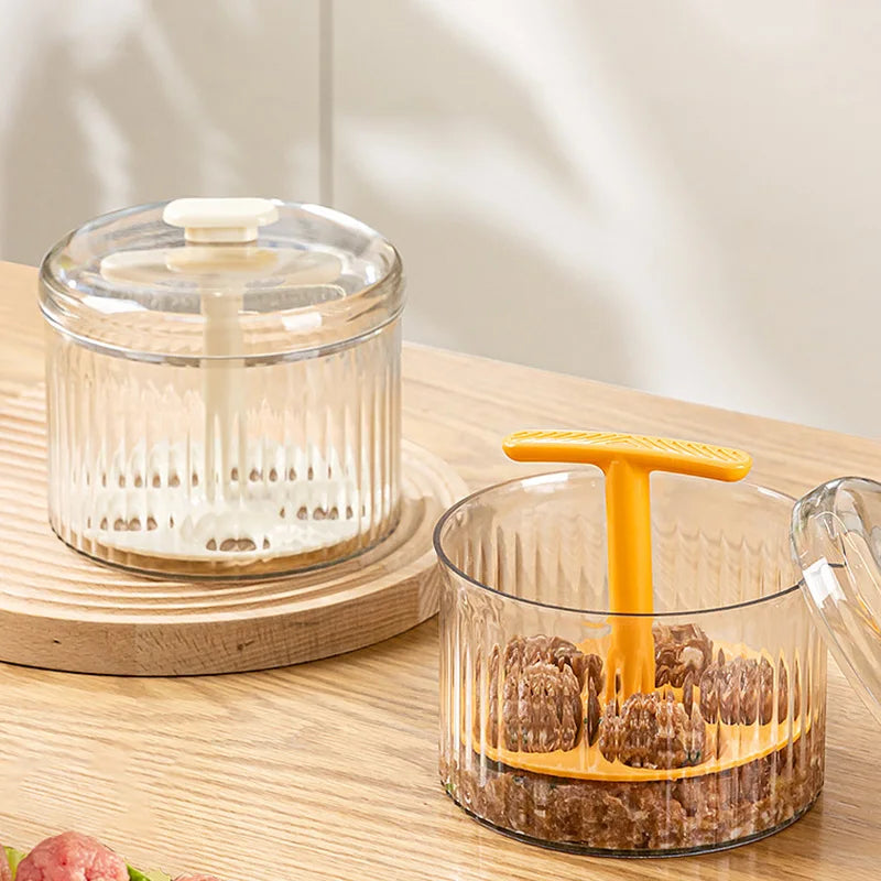 Two Meatball Makers, one empty and one with five meatballs, on a wooden surface with a transparent container design.