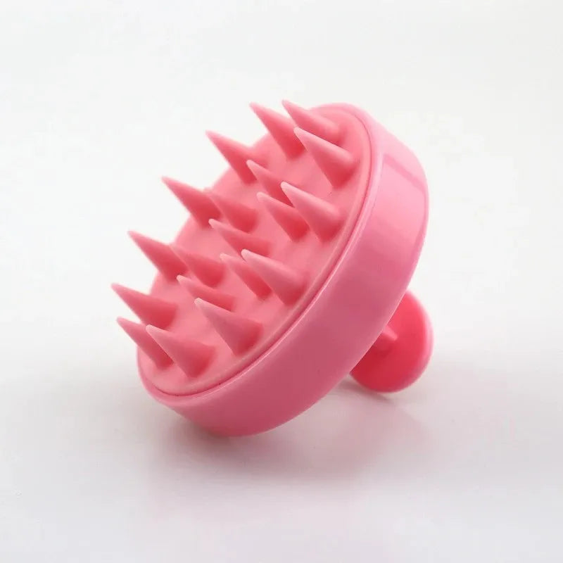 Pink silicone scalp massager with spikes on a white background