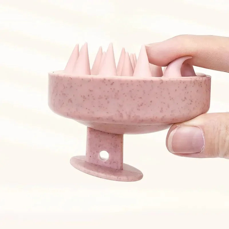 Pink silicone ring with textured design held by a hand against a light background