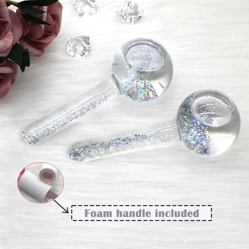 Two clear glass pipes with glittery accents on a white surface, with a foam handle included.