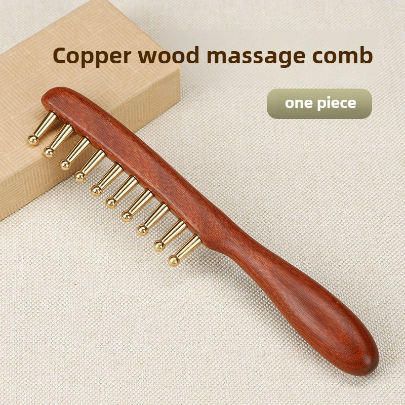 Copper wood massage comb on a beige background